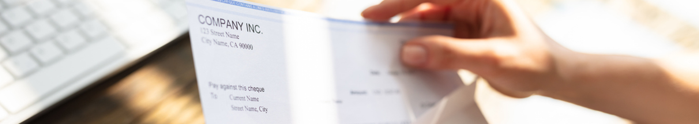 Compensation image for detail page, showing a paycheck being inserted into an envelope